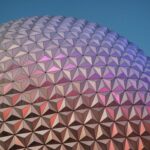 Close-up of a geodesic dome with vibrant colors reflecting at sunset.